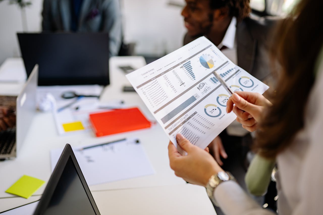 digital-01 Professionals reviewing business charts and documents in a team meeting.